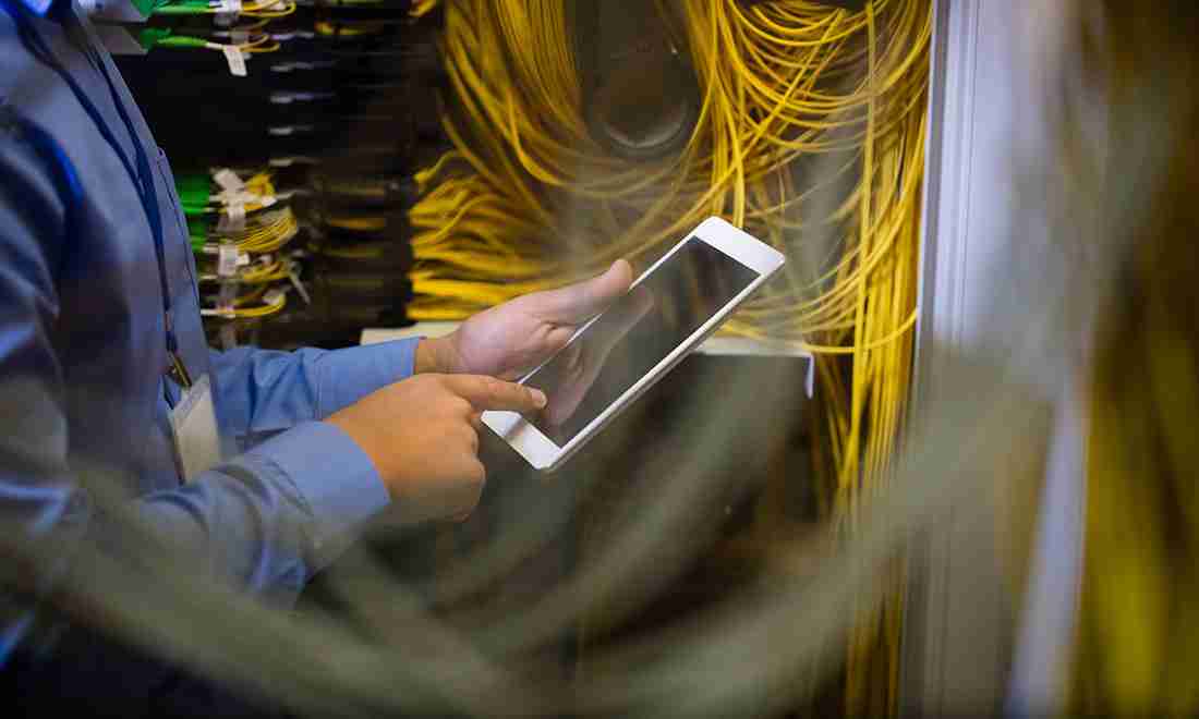 Network engineer managing enterprise network infrastructure and structured cabling systems in a server room